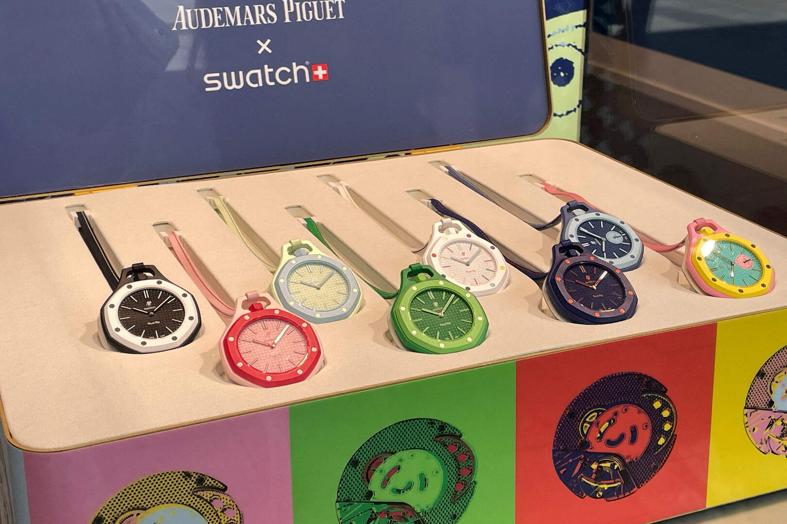 A selection of colourful Audemars Piguet × Swatch watches displayed in a presentation case, illustrating the Irish Independent article on the enduring appeal of Swatch.